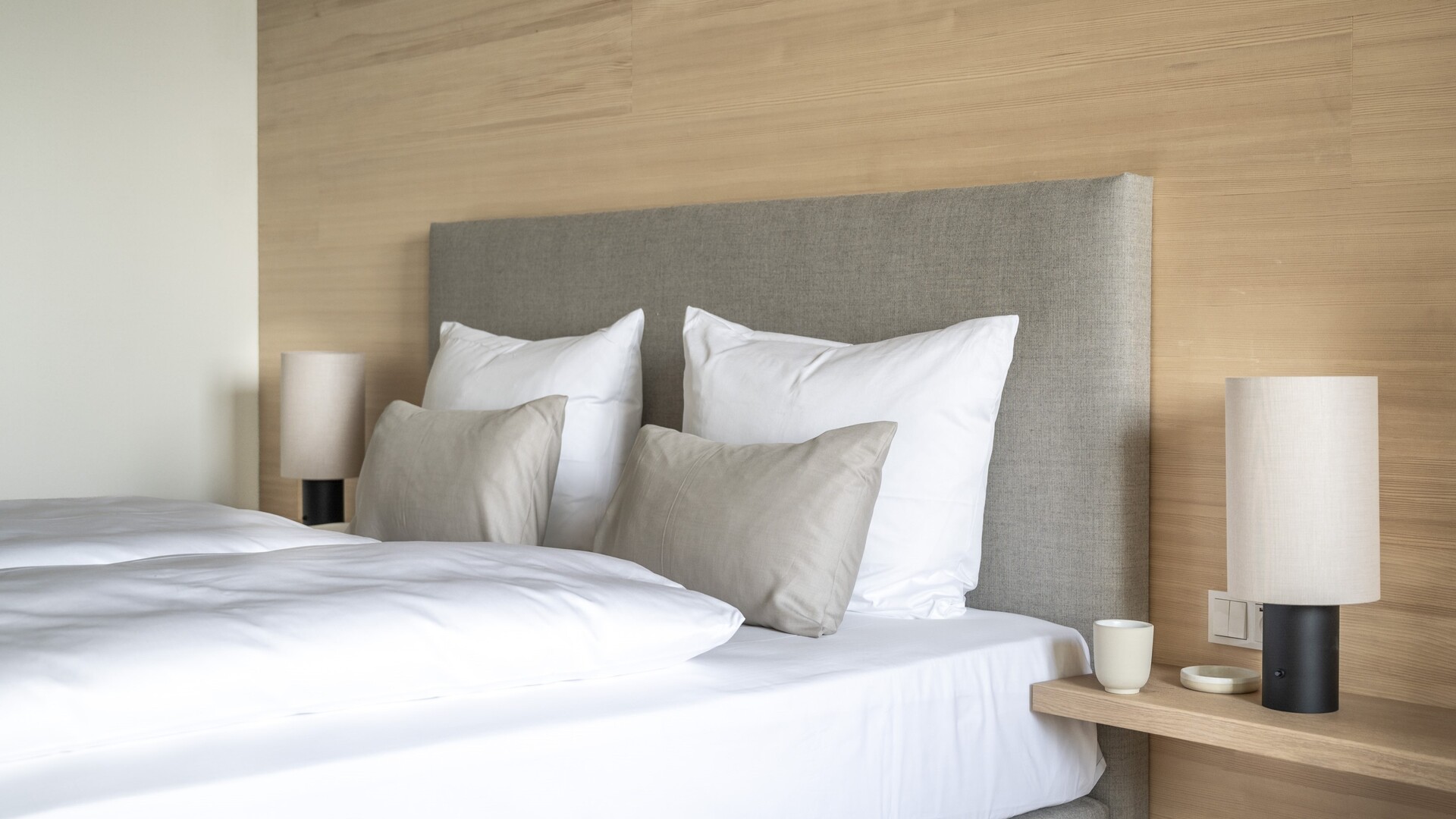 Hotel room with silver fir wood and box-spring bed at Seegut Zeppelin